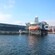 A large glass and steel building by the water